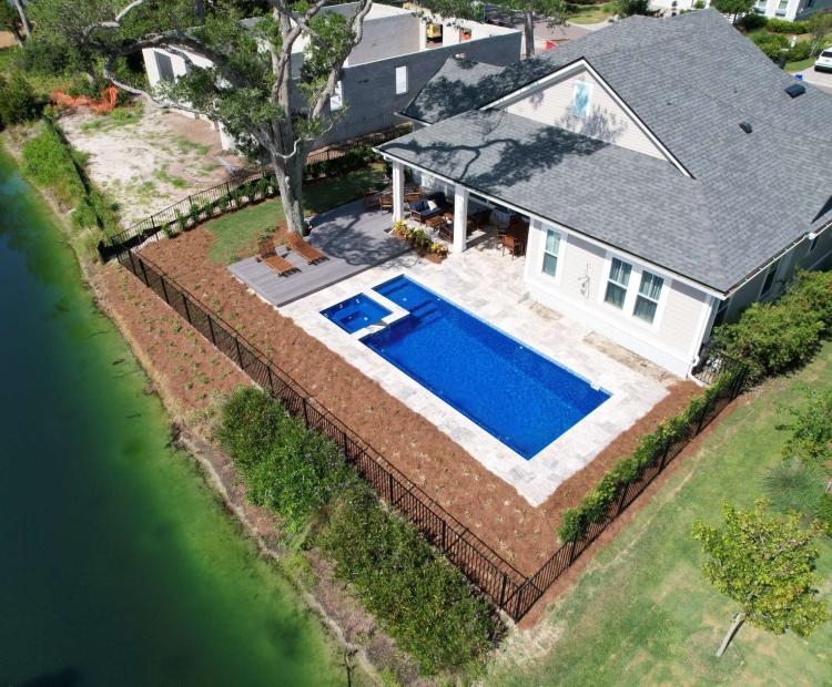 Completed residential swimming pool with surrounding patio