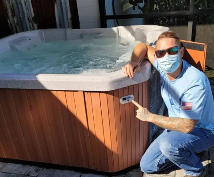 Pool professional inspecting residential pool equipment